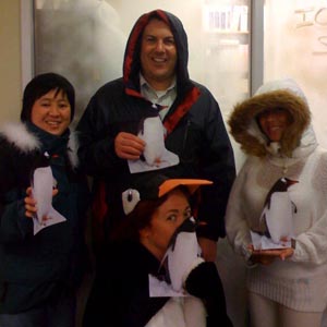Halloween group of Antarctic researchers with local penguins