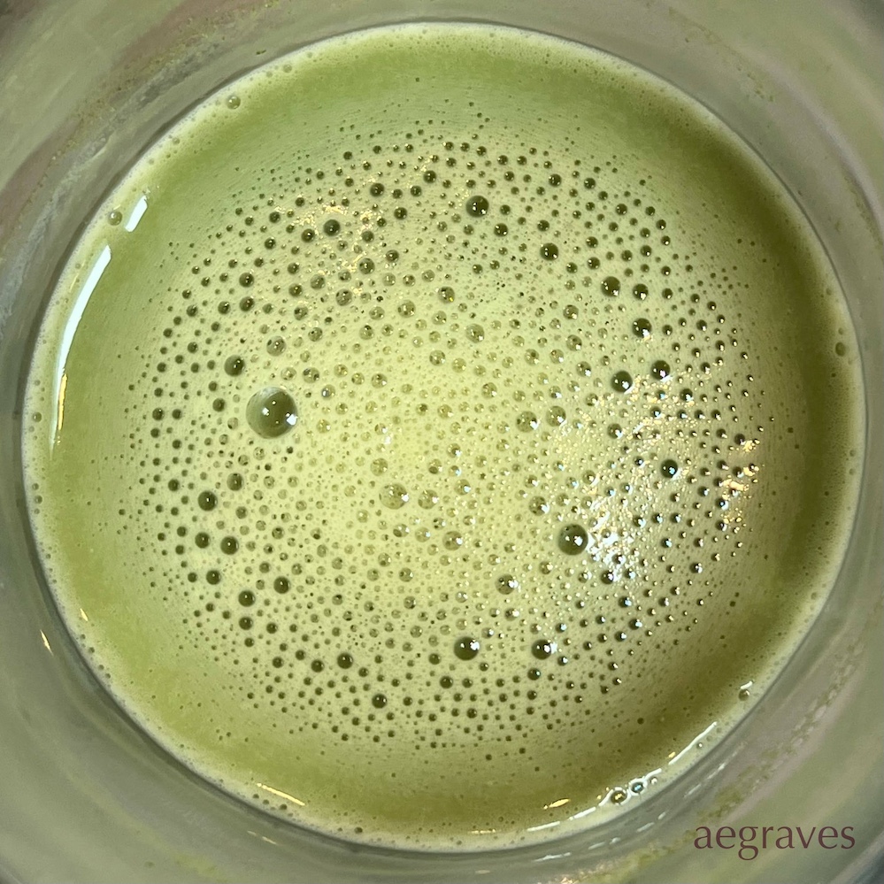 image looking down into the bubbles of a recently blended matcha latte