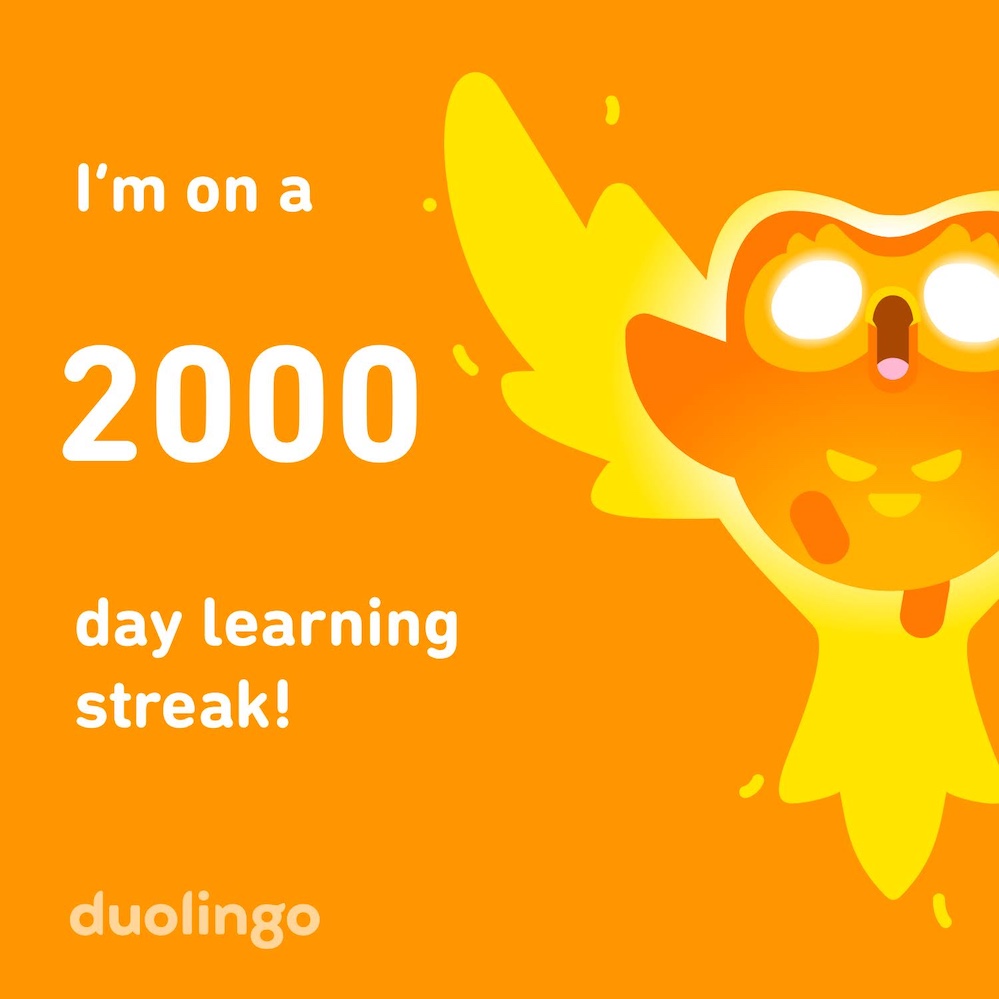 Duolingo sharing graphic in orange, with flaming orange owl plus text that reads, "I'm on a 2000 day learning streak!"