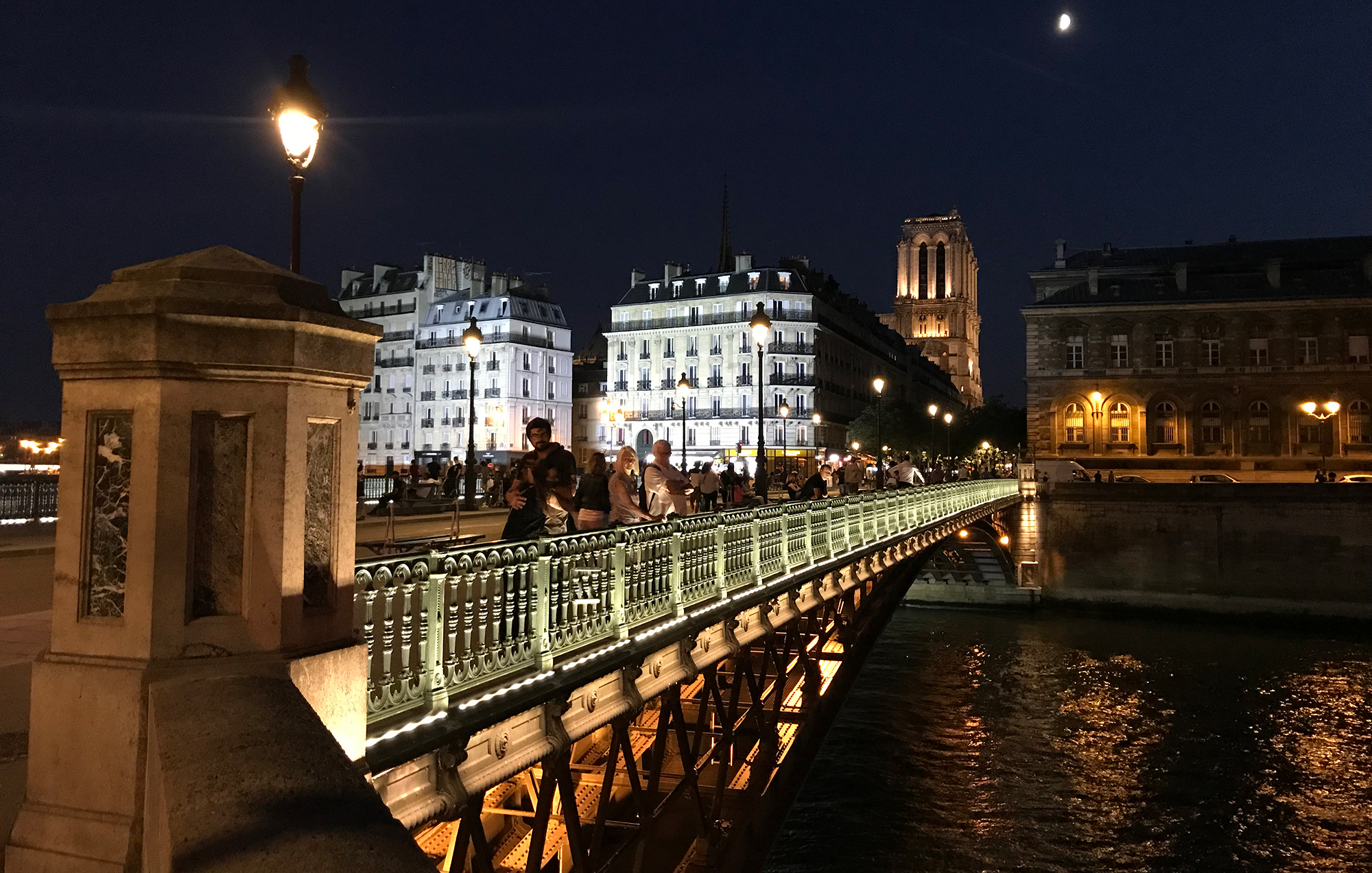 photo of a bridge over the Seine in Paris, France in the evening by A.E. Graves